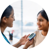 A pediatrician talks to a teenage patient about her blood sugar test results