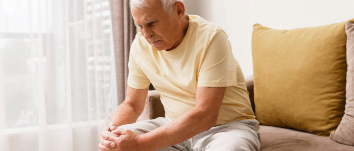 Senior patient holding his knee in pain due to osteoarthritis