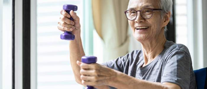 Older adult staying active to prevent osteoporosis by using light weights