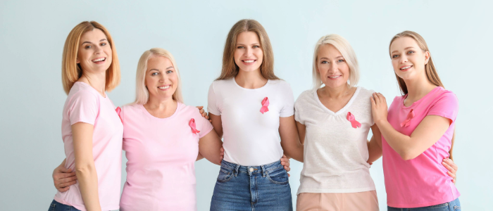 Women showing support during 乳腺癌 Awareness Month by wearing pink ribbons
