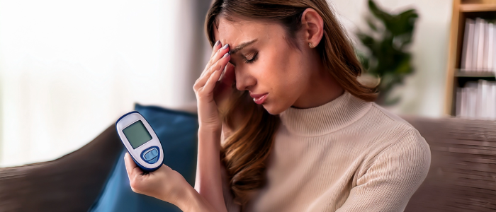 Person feeling overwhelmed while managing diabetes at home.