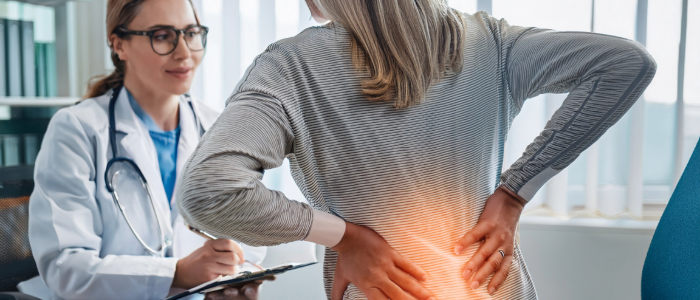 Patient consulting with a doctor about chronic lower back pain.