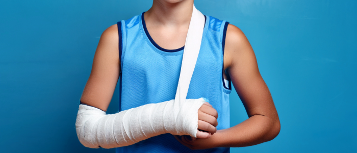 youth athlete wearing a white cast in a sling.